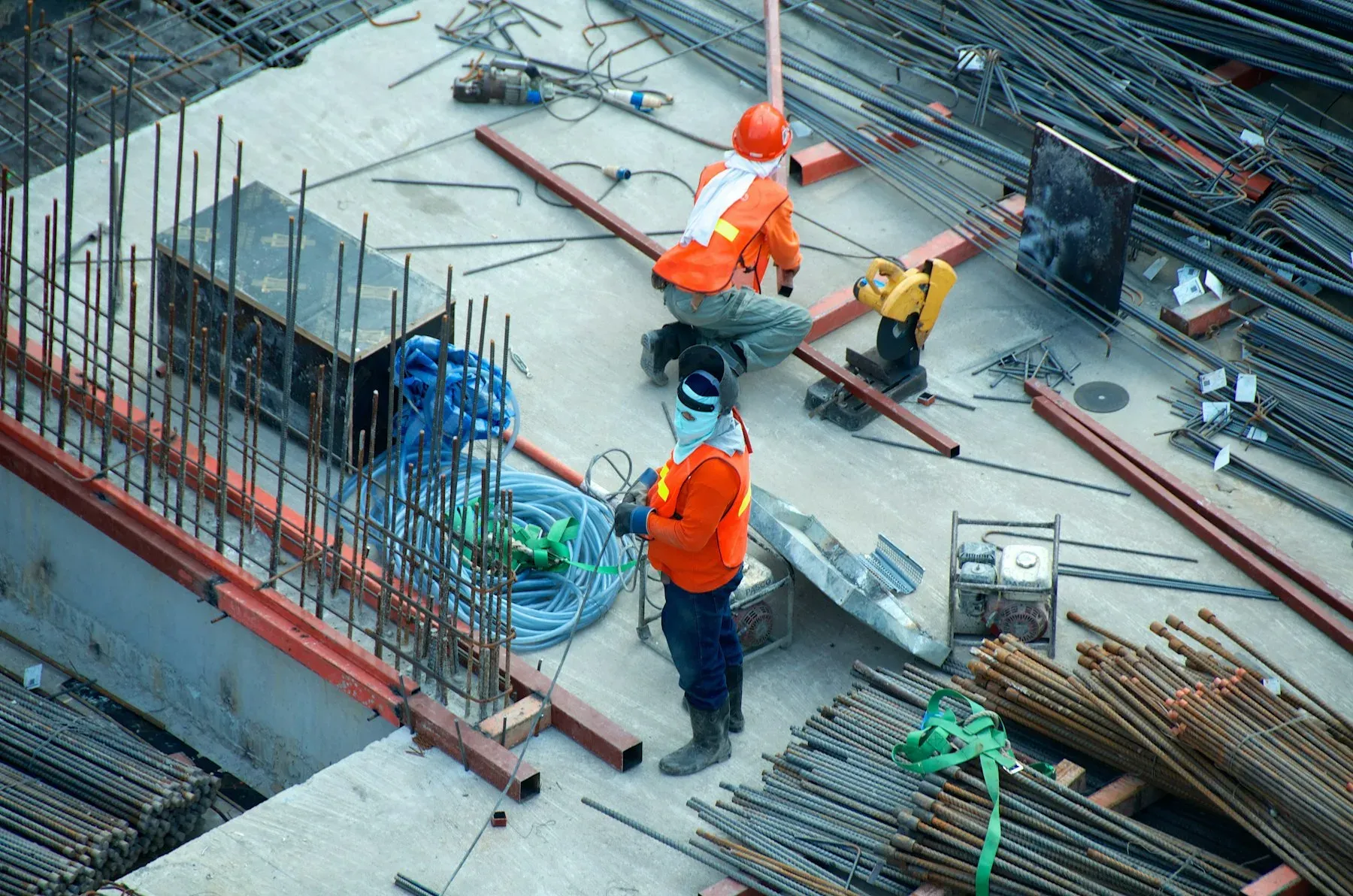 Workers assembling a structural steel frame on site