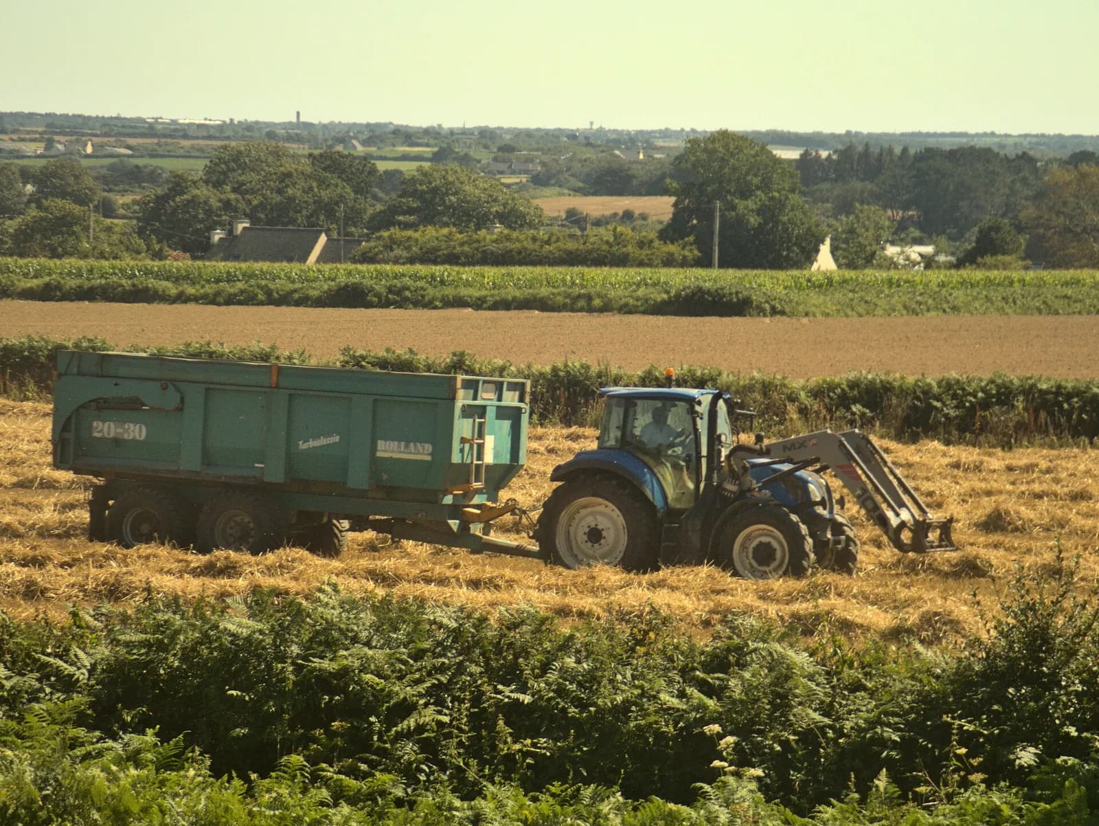 Tractor hauling a loaded trolley