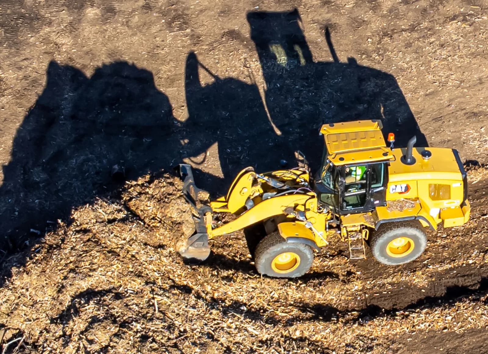 Front end loader loading material