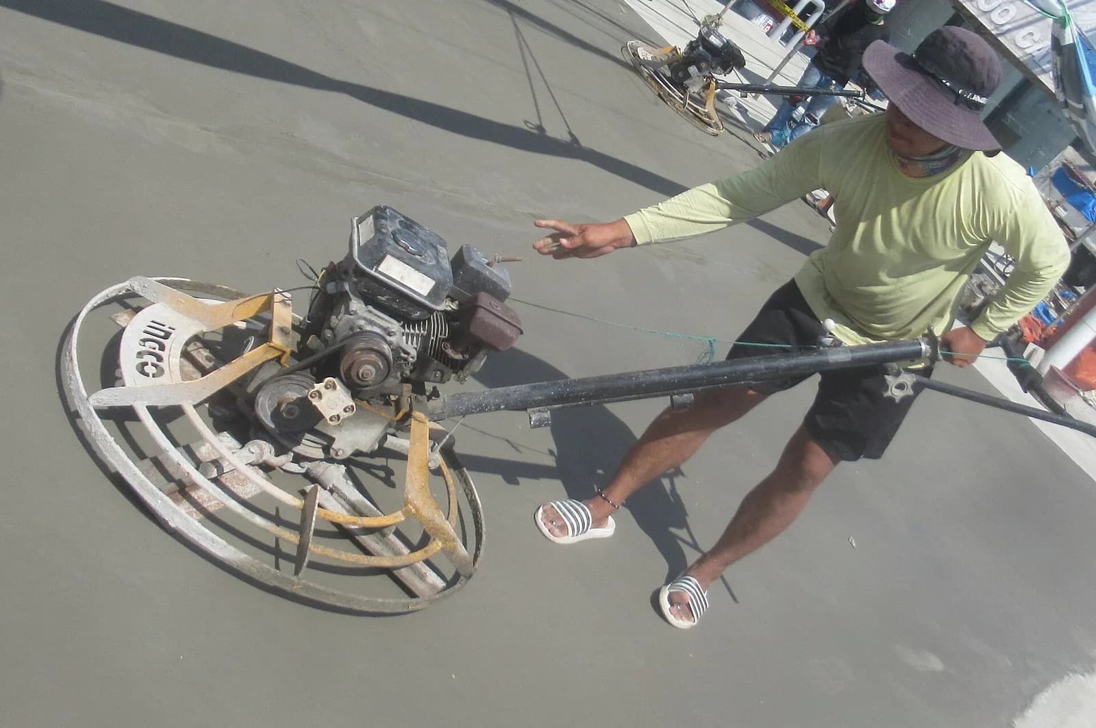 Power trowel finishing a concrete slab